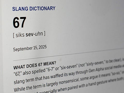 This Dictionary.com page shows the newest word of the year '6 7' on a computer screen.
