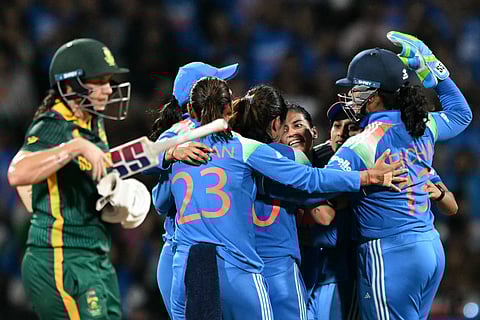 India's players celebrate after the dismissal of South Africa's Tazmin Brits during the ICC Women's Cricket World Cup 2025 one-day international (ODI) final match between India and South Africa at the DY Patil Stadium in Navi Mumbai on November 2, 2025.