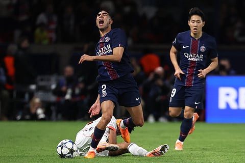 Bayern Munich's Colombian forward #14 Luis Diaz (DOWN) tackles Paris Saint-Germain's Moroccan defender #02 Achraf Hakimi during the UEFA Champions League, league phase day 4, football match between Paris Saint-Germain (PSG) and FC Bayern Munich at the Parc des Princes in Paris, on November 4, 2025.