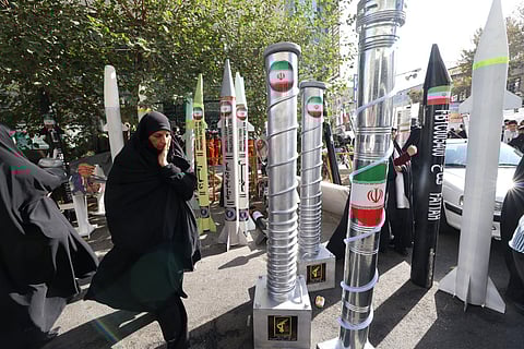 Models of missiles and nuclear centrifuges displayed during a rally outside the former US Embassy in Tehran on November 4, 2025, marking the 46th anniversary of the 1979 hostage crisis.