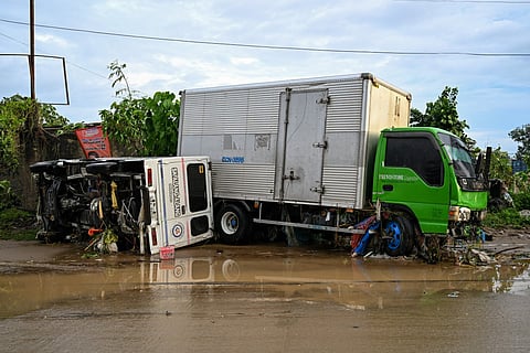 Damaged vehicles are seen along a road in the aftermath of Typhoon Kalmaegi in Mandaue City, Cebu province on November 5, 2025.