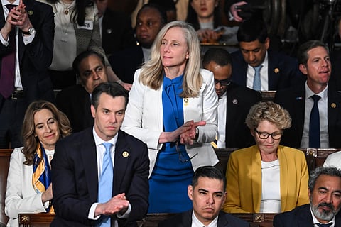 US Representative Abigail Spanberger (C), Democrat of Virginia, stands and applauds as US President Joe Biden delivers the State of the Union address in the House Chamber of the US Capitol in Washington, DC, on March 7, 2024.