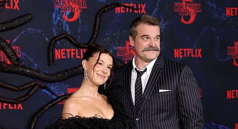 Millie Bobby Brown and David Harbour attend the Los Angeles Premiere of Netflix's "Stranger Things" Season 5 at TCL Chinese 6 Theatres on November 06, 2025 in Hollywood, California.