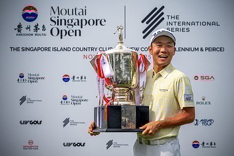 Japan's Yosuke Asaji posing with the trophy after the 2025 Moutai Singapore Open golf tournament at the Singapore Island Country Club golf course in Singapore.