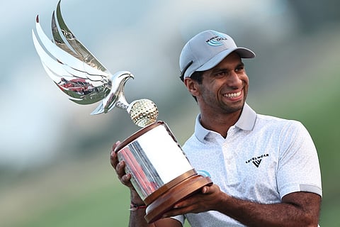 England's Aaron Rai poses with the trophy after winning the European Tour of Abu Dhabi Championship 2025 golf tournament in Abu Dhabi on November 9, 2025.