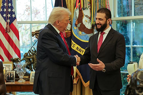 In this photo released by Syrian Presidency press office, President Donald Trump, left, shakes hands with Syria's President Ahmad Al-Sharaa, at the White House in Washington, Monday, Nov. 10, 2025.