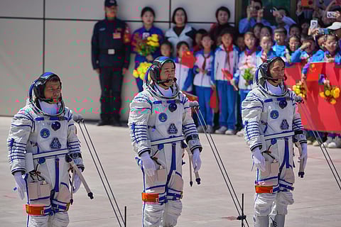 FILE - Chinese astronaut for the Shenzhou 20 mission, Chen Dong, center, speaks next to his comrades Chen Zhongrui, right, and Wang Jie as they attend a send-off ceremony for their manned space mission at the Jiuquan Satellite Launch Center in northwestern China, Thursday, April 24, 2025. (AP Photo/Andy Wong, file)