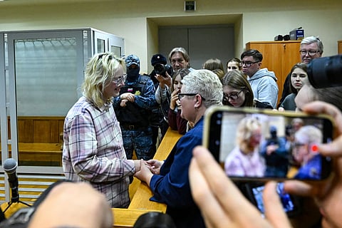 Diana Loginova, the-18-year-old music student, street musician and lead singer of the Stoptime band known by the stage name Naoko, who was earlier arrested after her performances of songs by exiled Russian artists known for their opposition to the the country's military campaign in Ukraine, and served two short jail terms for "disrupting public order" and "petty hooliganism", interacts with her mother Irina as she appears in court over new public order charges in Saint Petersburg on November 11, 2025.