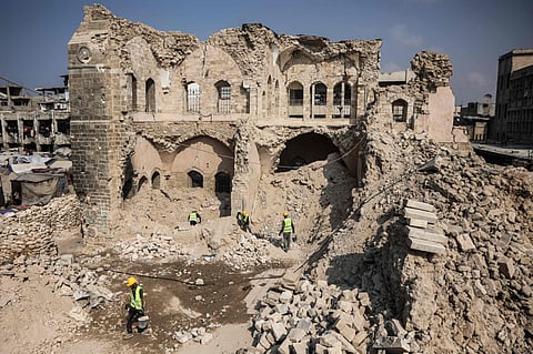 Workers start the rehabilitation on what remains of the Pasha Palace Museum, damaged by two years of fighting between Israel and Hamas, in Gaza City on November 11, 2025.