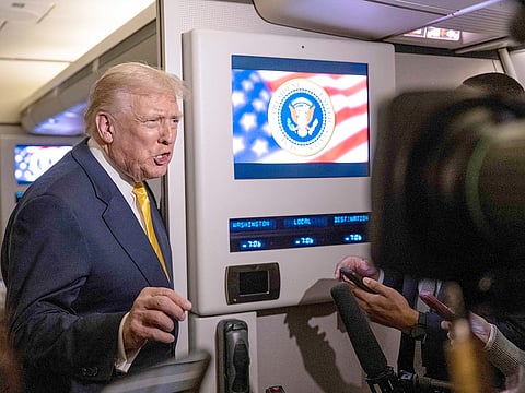 US President Donald Trump speaks to members of press aboard Air Force One on November 14, 2025 while in flight from Washington, DC to West Palm Beach International Airport.
