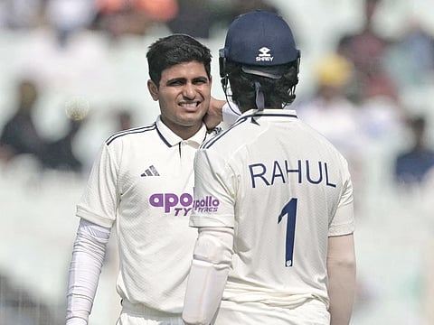 India's captain Shubman Gill (L) reacts after being injured during the second day of the first Test match against South Africa at the Eden Gardens in Kolkata on November 15, 2025.