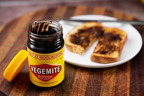 A piece of toast is prepared with Vegemite in Sydney, Australia, Monday, Nov. 17, 2025. (AP Photo/Rick Rycroft)