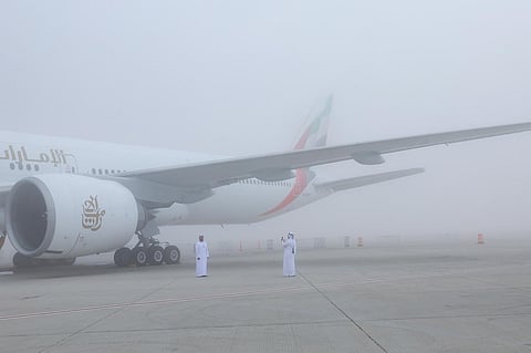 Participants at the Dubai Airshow amid dense fog.
