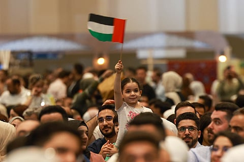 A young girl waves the UAE flag at the ‘Emirates Loves Syria’ event in Expo City Dubai.