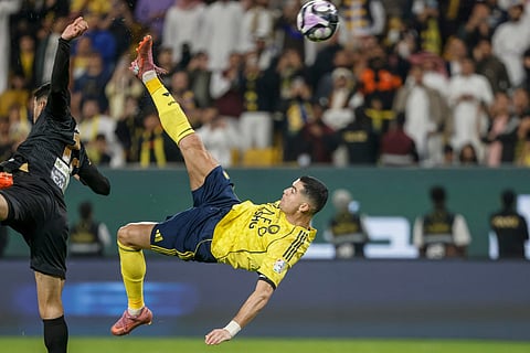 Nassr's Portuguese forward #07 Cristiano Ronaldo (R) kicks the ball to score his team's fourth goal during the Saudi Pro League football match between Al-Nassr and Al-Khaleej at Al-Awwal Park in Riyadh on November 23, 2025.