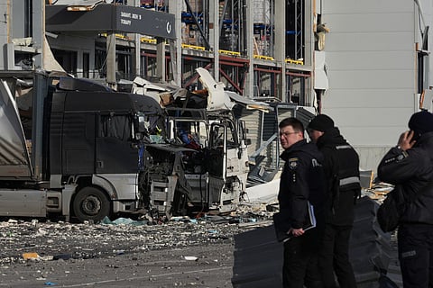 Law enforcement officers work at the site of the heavily damaged logistics hub of the Novus supermarket following Russian missiles and drones strikes in Kyiv on November 25, 2025.