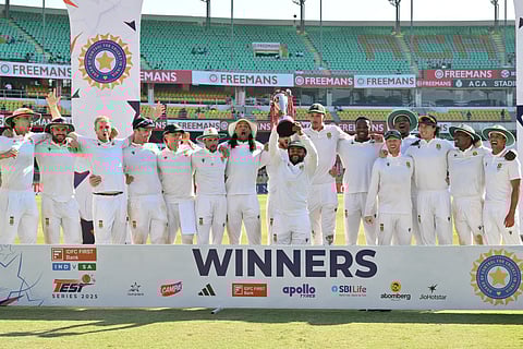 South Africa's players pose with the trophy to celebrate their win in the end of the fifth day of the second Test cricket match against India at the Barsapara Cricket Stadium in Guwahati on November 26, 2025.