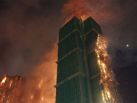 Fire burns bamboo scaffolding across multiple buildings in Hong Kong (Photo/Reuters)