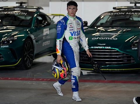 RB's French-Algerian driver Isack Hadjar walks down the pitlane during the sprint qualifying session ahead of the Formula One Qatar Grand Prix at the Lusail International Circuit in Lusail on November 28, 2025.