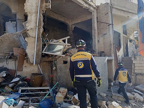 Syrian Civil Defence workers check a house that was destroyed during an Israeli forces raid in the southern Syrian village of Beit Jin, Syria, on Friday, November 28, 2025.