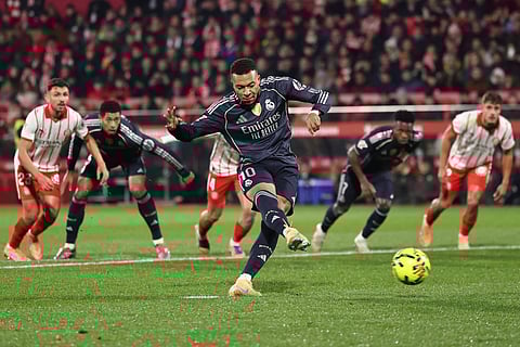 Real Madrid's French forward Kylian Mbappe scores a goal from the penalty spot during the Spanish league football match against Girona FC at Montilivi Stadium in Girona on November 30, 2025.