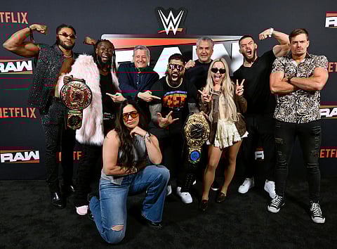 Trick Williams, Kofi Kingston, Ted Sarandos, Co-CEO, Netflix, Raquel Rodriguez, Jey Uso, Nick Khan, President of WWE, Liv Morgan, Austin Theory, and Grayson Waller attend Netflix & WWE "Monday Night RAW" Brunch at MGM Grand Hotel & Casino on April 21, 2025 in Las Vegas, Nevada.