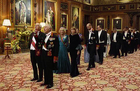 Germany's President Frank-Walter Steinmeier and Britain's King Charles III, followied by Britain's Queen Camilla and Elke Buedenbender and then Britain's Catherine, Princess of Wales and Britain's Prince William, Prince of Wales lead guests as they arrive to attend a State Banquet at Windsor Castle in Windsor, on December 3, 2025, the first day of a three day state visit by the German President.