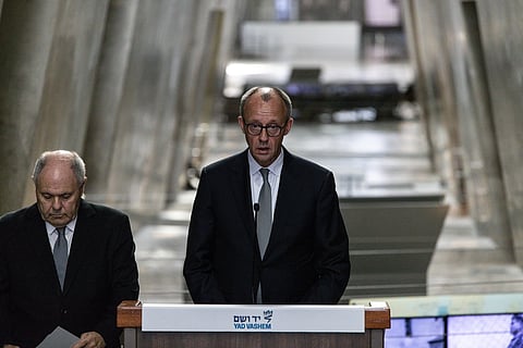 German Chancellor Friedrich Merz, right, makes a statement next to Dani Dayan, chairman of the Yad Vashem Holocaust Memorial Museum in Jerusalem, Sunday, Dec. 7, 2025. (John Wessels, Pool Photo via AP)