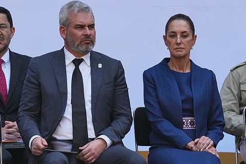FILE - Michoacán State Governor Alfredo Ramirez Bedolla, left, and Mexican President Claudia Sheinbaum attend a presentation of the new security strategy against violence for the state of Michoacan, at the National Palace in Mexico City, Nov. 9, 2025. (AP Photo/Claudia Rosel, File)