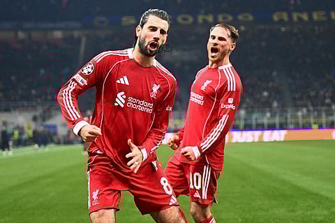 Liverpool's Hungarian midfielder #08 Dominik Szoboszlai celebrates scoring a penalty kick with Liverpool's Argentinian midfielder #10 Alexis Mac Allister during the UEFA Champions League phase day 6 football match between Inter Milan and Liverpool at San Siro stadium in Milan, on December 9, 2025.