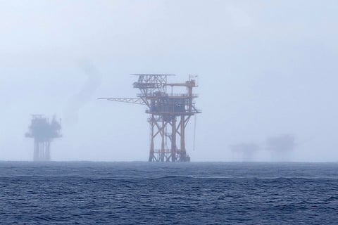 FILE - Oil platforms are visible through the haze near the Flower Garden Banks National Marine Sanctuary in the Gulf of Mexico, off the coast of Galveston, Texas, Saturday, Sept. 16, 2023.