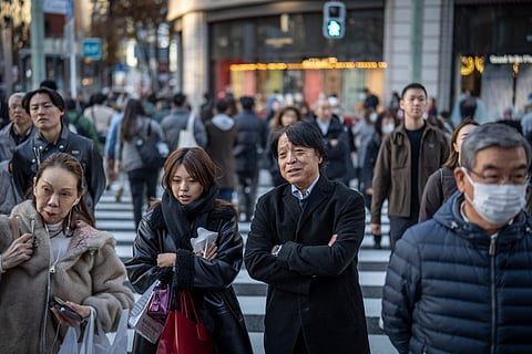 People cross a street in the Ginza area of Tokyo on December 11, 2025. Representational image.