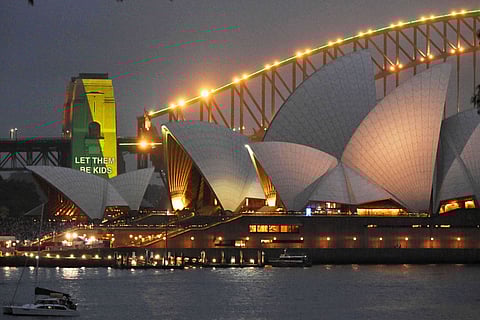 The social media ban for children under 16 slogan "Let Them Be Kids" is projected onto the pylons of the Sydney Harbour Bridge in Sydney, Wednesday, Dec. 10, 2025. (Mick Tsikas/AAP Image via AP)