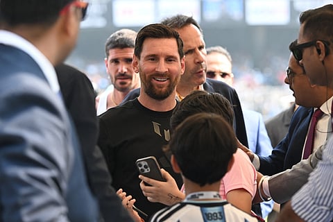 A fan takes a selfie with Inter Miami's Argentine forward #10 Lionel Messi at the Salt Lake Stadium in Kolkata on December 13, 2025.