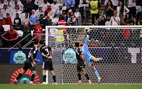 UAE goalkeeper Hamad Al Meqbaali makes a late save against Algeria.