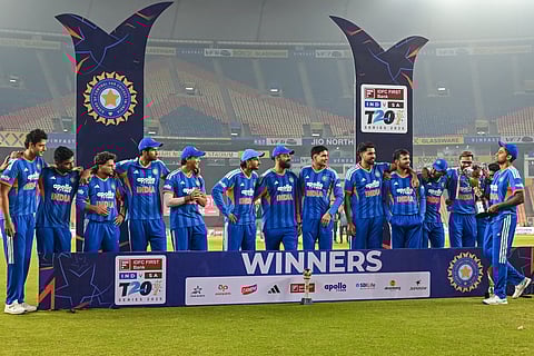 India's captain Suryakumar Yadav (R), along with team players, celebrates with the trophy after winning the series against South Africa at the end of the fifth Twenty20 international cricket match at the Narendra Modi Stadium in Ahmedabad on December 19, 2025.
