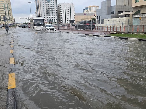 Vehicles navigate floodwaters at Al Estiqlal Square in Sharjah following heavy Friday downpour.