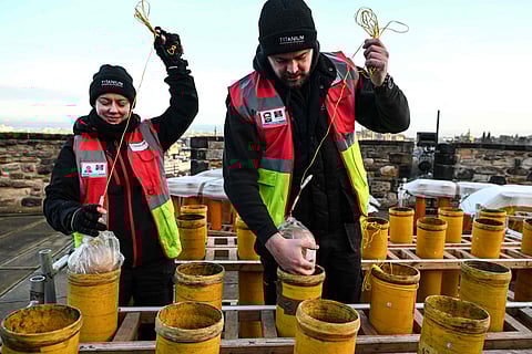Pyrotechnicians Lynn Wiseman (L) and Sam Hutchinson (R) prepare New Year