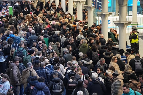 Travellers are pictured at St. Pancras station in London on December 30, 2025, as Eurostar train service between Britain and continental Europe is halted.