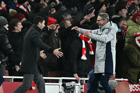 Arsenal's Spanish manager Mikel Arteta (L) celebrates with Dutch assistant coach Albert Stuivenberg (R) after they score their fourth goal during the English Premier League football match against Aston Villa at the Emirates Stadium in London on December 30, 2025.