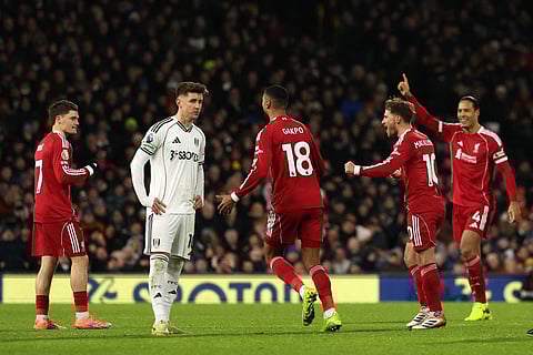Liverpool's German midfielder #07 Florian Wirtz (L) celebrates with teammates after VAR overturned the offside decision for Liverpool's first goal to equalise 1-1 during the English Premier League football match between Fulham and Liverpool at Craven Cottage in London on January 4, 2026.