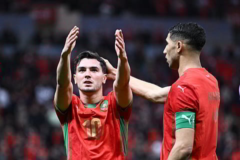 Morocco's forward Brahim Diaz celebrates scoring his team's first goal next to Morocco's defender Achraf Hakimi during the Africa Cup of Nations round of 16 football match against Tanzania at Prince Moulay Abdallah Stadium in Rabat on January 4, 2026.