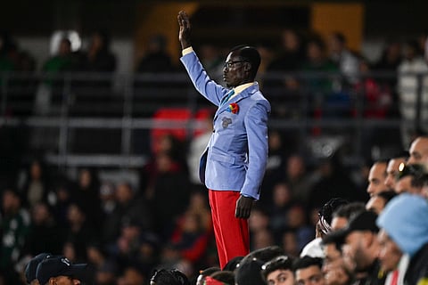 Democratic Republic of Congo's supporter Michel Kuka Mboladinga, pays tribute to Democratic Republic of Congo's late prime minister Patrice Lumumba, by remaining motionless before the Africa Cup of Nations (CAN) round of 16 football match between Algeria and Democratic Republic of Congo at the Prince Moulay El Hassan Stadium in Rabat on January 6, 2026.