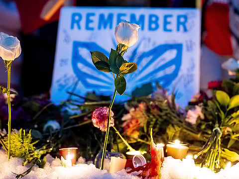 Flowers are seen at a protest and vigil after an Immigration and Customs Enforcement officer shot and killed a woman in Minneapolis.