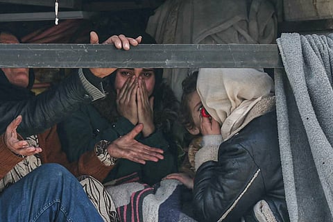 A resident reacts as she and others flee in the back of a truck, the predominantly Kurdish neighbourhoods of Sheikh Maqsud and Ashrafiyeh in the city of Aleppo on January 8, 2026, amid intense clashes between government forces and the Kurdish Syrian Democratic Forces (SDF) forces.