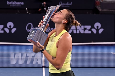 Aryna Sabalenka of Belarus celebrates with the trophy after winning the women's singles final against Marta Kostyuk of Ukraine at the Brisbane International tennis tournament in Brisbane on January 11, 2026.