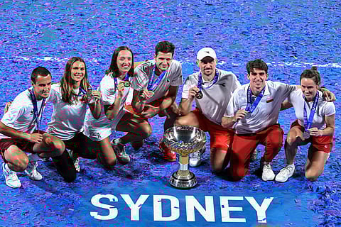 Poland's team celebrates with the winning trophy after clinching the United Cup tennis title in Sydney on January 12, 2026.