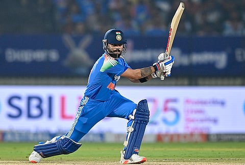 India's Virat Kohli watches the ball after playing a shot during the first one-day international (ODI) cricket match between India and New Zealand at the Kotambi Stadium in Vadodara on January 11, 2026.