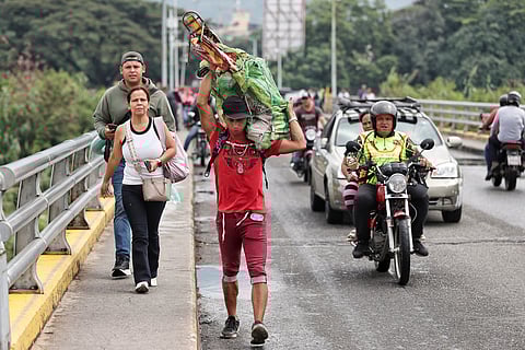 Pedestrians cross the border from Venezuela to Villa del Rosario, Colombia, Monday, Jan. 5, 2026, two days after U.S. forces captured and removed Venezuelan President Nicolas Maduro. (AP Photo/Santiago Saldarriaga)