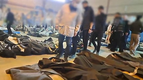 Dozens of bodies lying inside the Tehran Province Forensic Diagnostic and Laboratory Centre in Kahrizak, with what appears to be grieving relatives searching for loved ones.